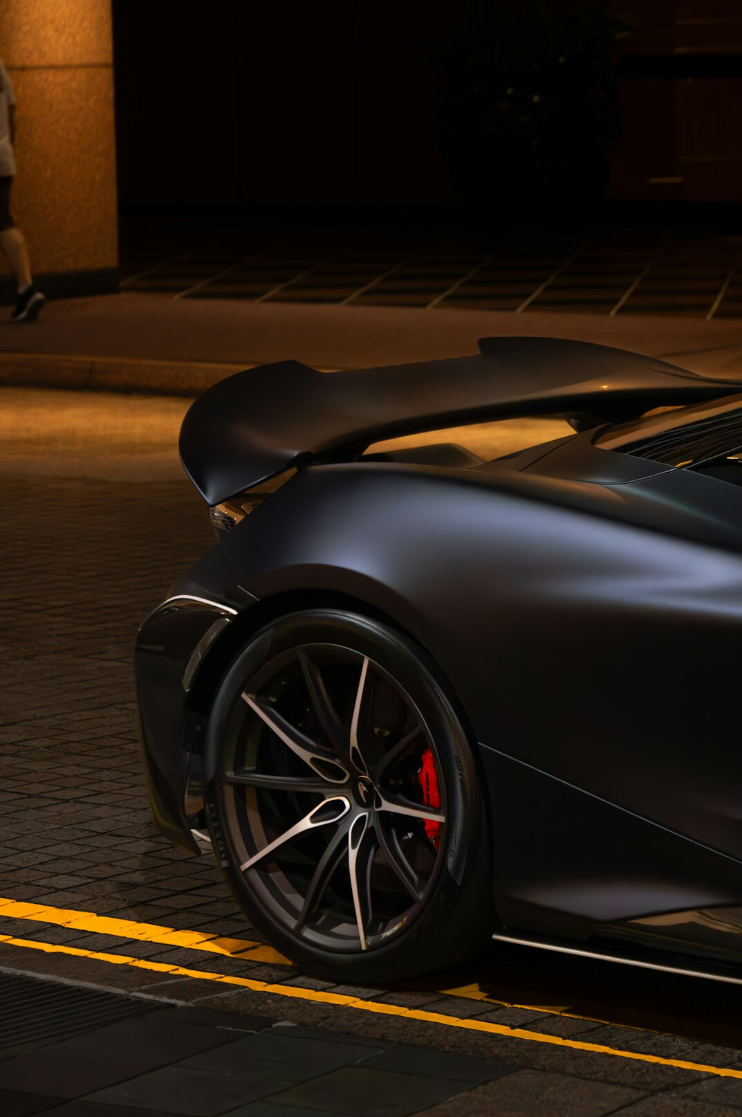 Modern hypercar with aggressive aerodynamic design photographed at night