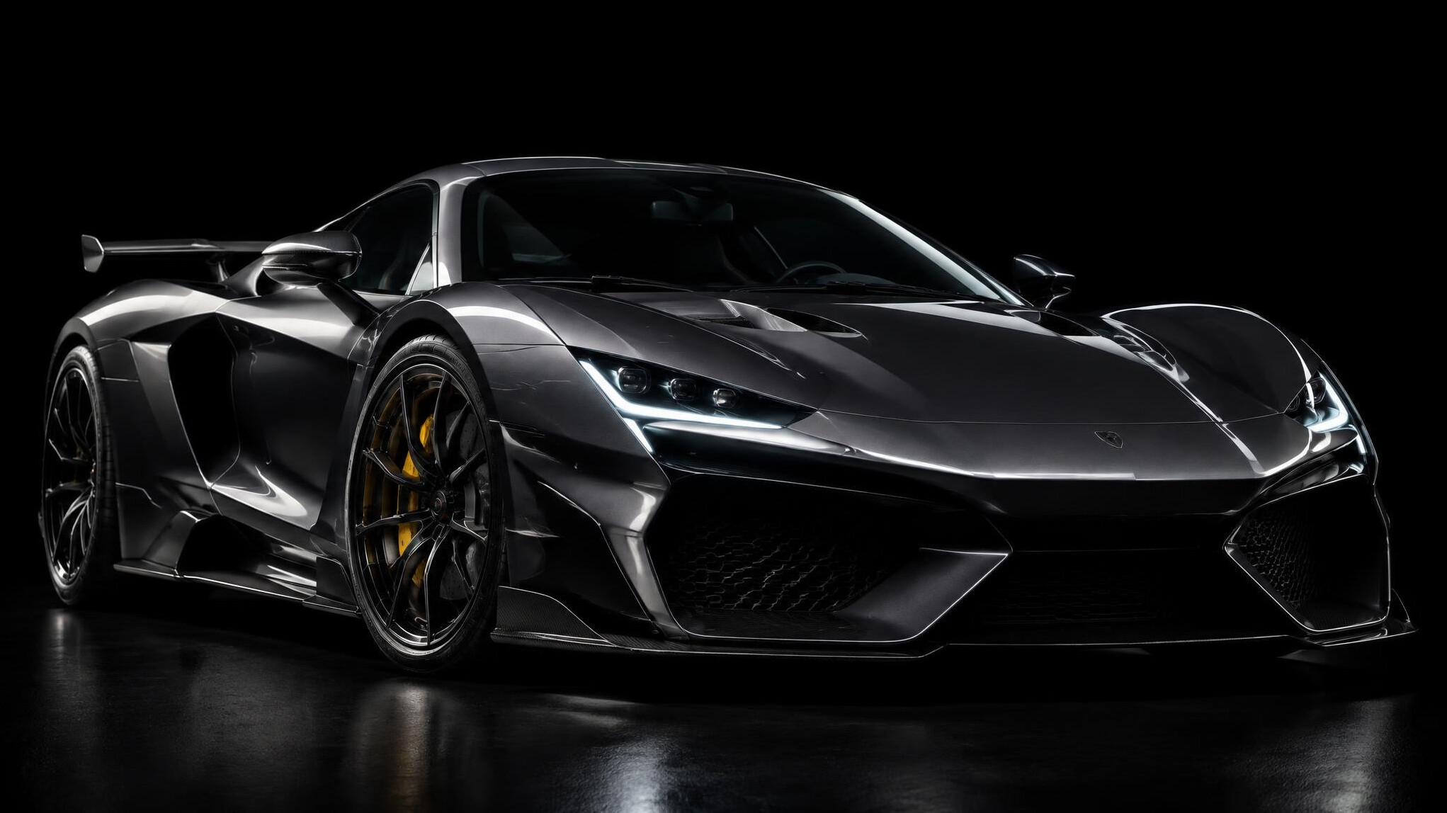 Studio photograph of a modern hypercar from a low front angle against dark background