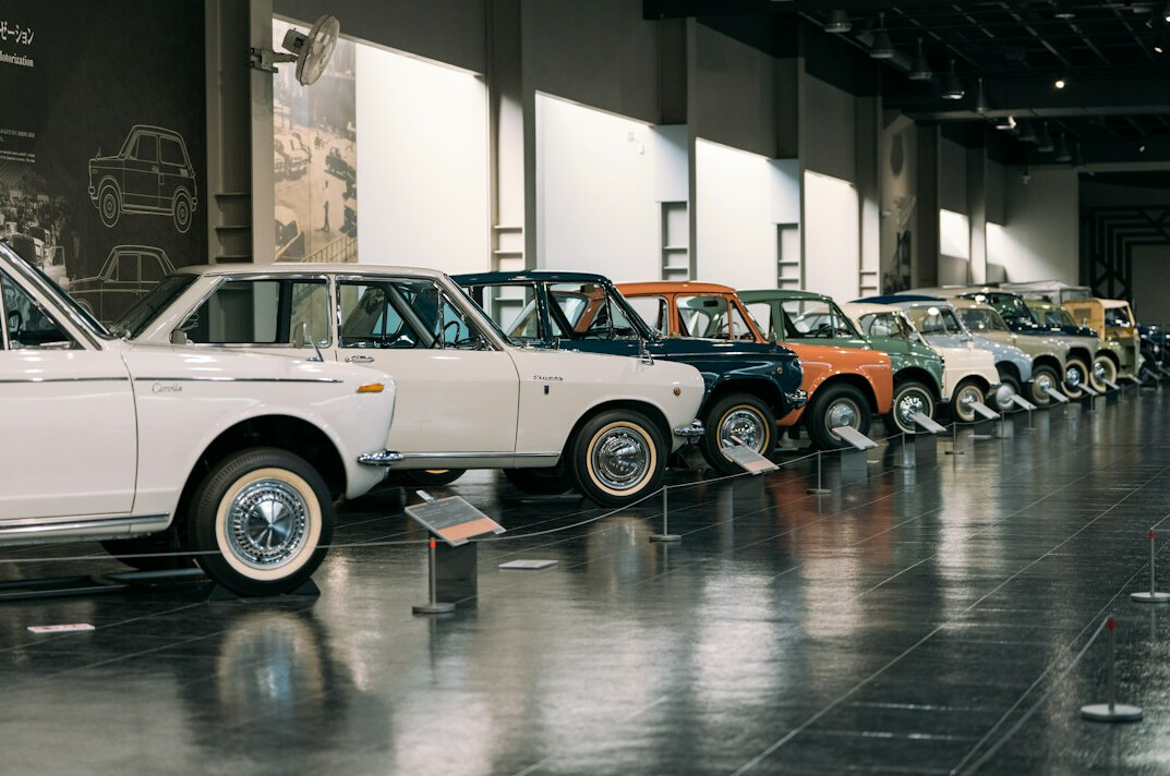 Interior of a classic car museum with rows of restored vintage automobiles